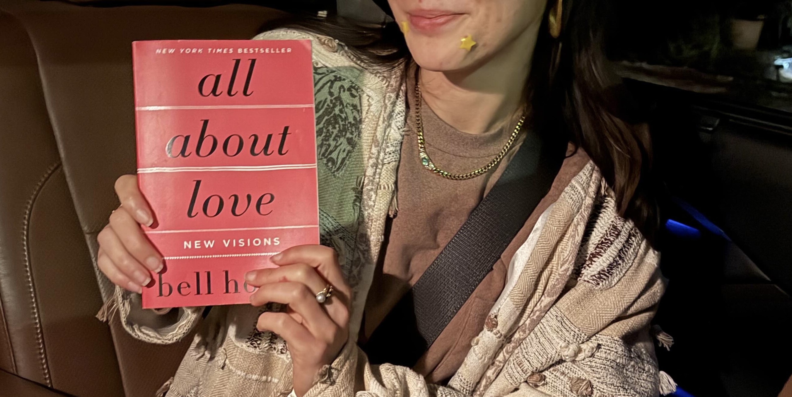 Holding All About Love by bell hooks